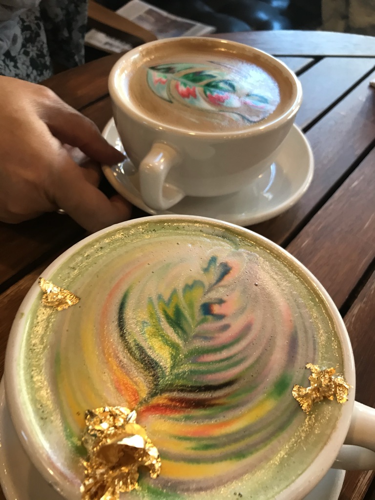 Rainbow latte with gold decoration for delight!
